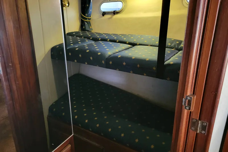 Slide: The Image of 1991 Bayliner 4588 Pilothouse cabin with cozy bunk beds and nautical decor. - 30