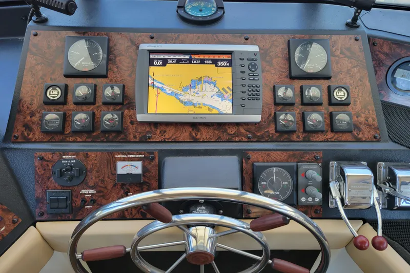 Slide: The Image of 1991 Bayliner 4588 Pilothouse dashboard with navigation system and controls. - 18