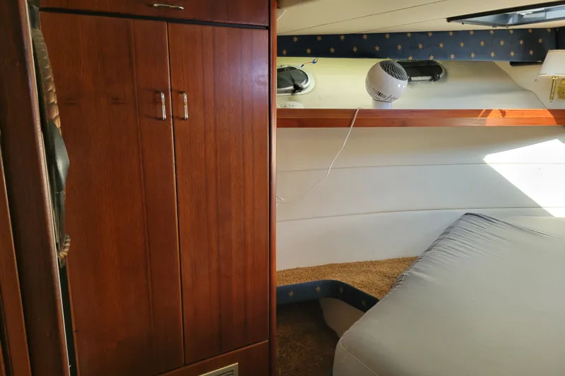 Slide: The Image of Interior cabin of 1991 Bayliner 4588 Pilothouse with wooden cabinetry and cozy sleeping area. - 32