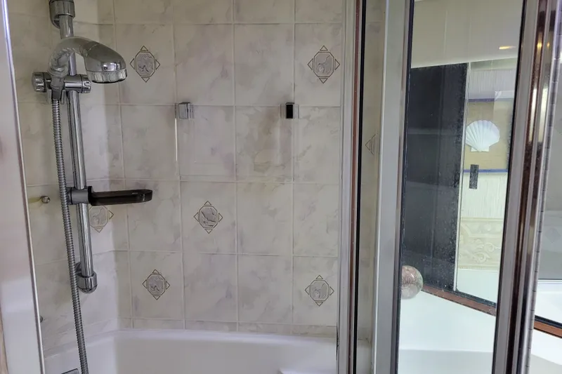 Slide: The Image of Shower area in 1991 Bayliner 4588 Pilothouse with tiled walls and chrome fixtures. - 29