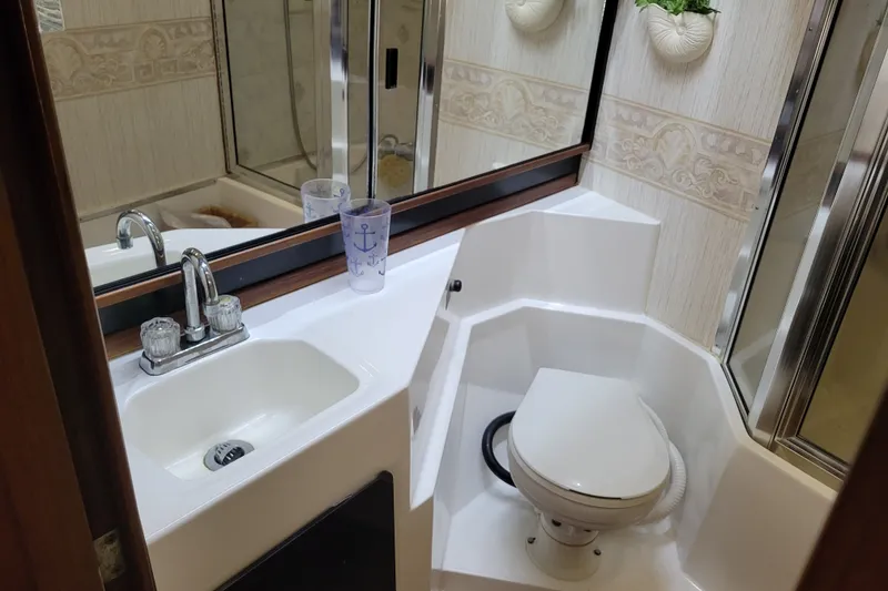 Slide: The Image of Bathroom interior of 1991 Bayliner 4588 Pilothouse yacht, featuring sink and toilet. - 34