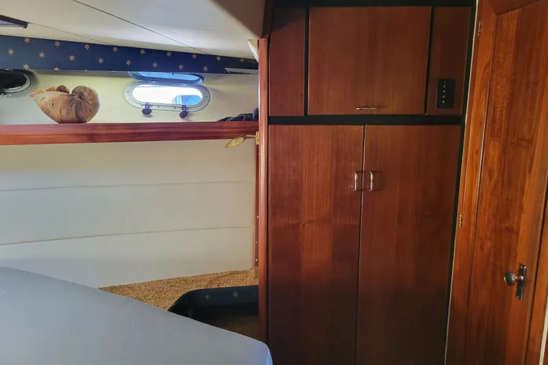Slide: The Image of Interior cabin of 1991 Bayliner 4588 Pilothouse with wooden cabinetry and porthole window. - 33