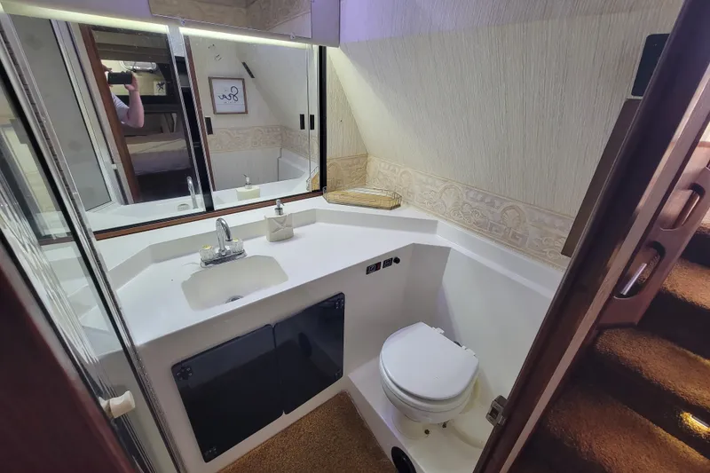 Slide: The Image of Bathroom interior of 1991 Bayliner 4588 Pilothouse yacht, featuring sink and toilet. - 28