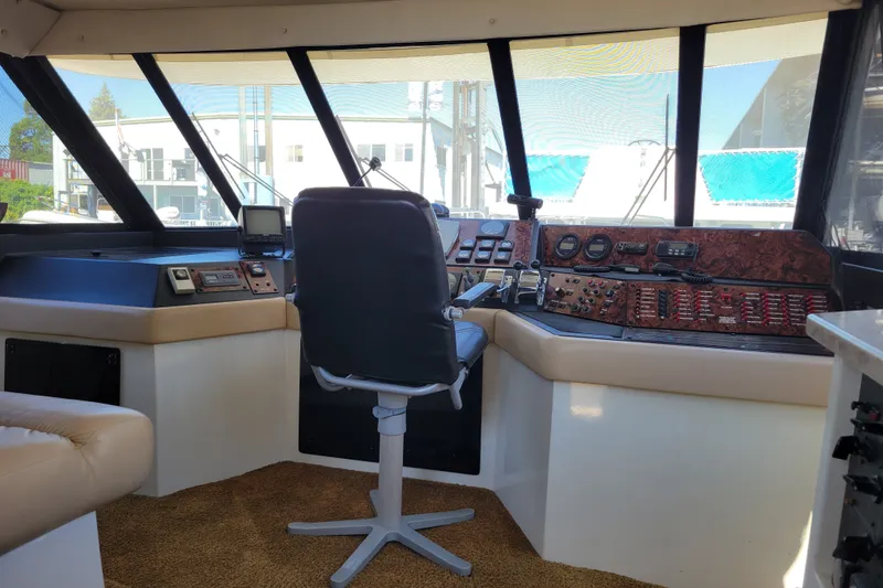 Slide: The Image of Interior of 1991 Bayliner 4588 Pilothouse with captain's chair and control panel. - 15