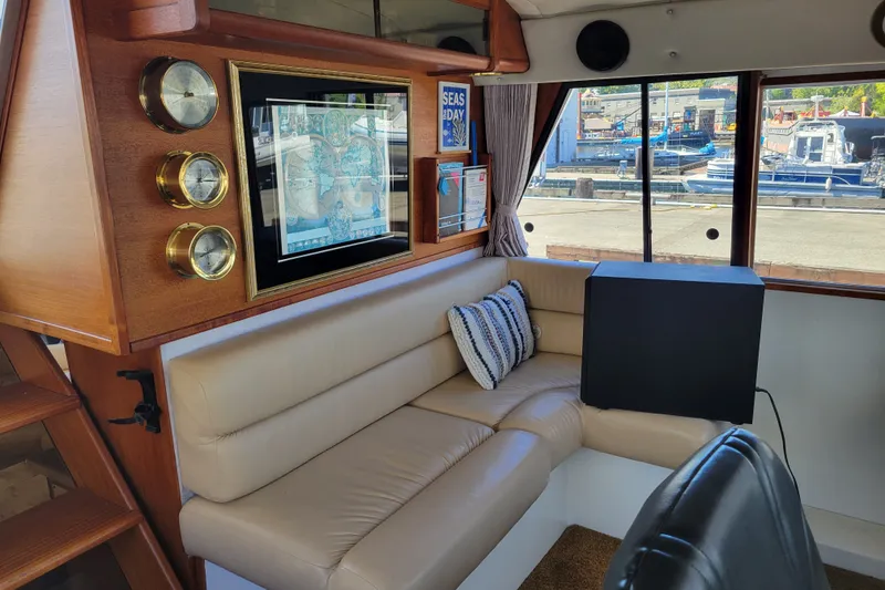Slide: The Image of Luxurious interior of 1991 Bayliner 4588 Pilothouse with leather seating and nautical decor. - 16
