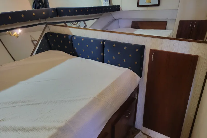 Slide: The Image of Interior cabin of 1991 Bayliner 4588 Pilothouse with cozy bed and nautical decor. - 27