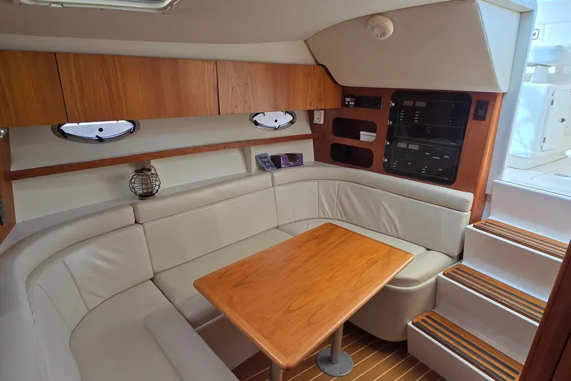 Slide: The Image of Luxurious interior of 2000 Tiara Yachts 3100 Open with cozy seating and wooden accents. - 15