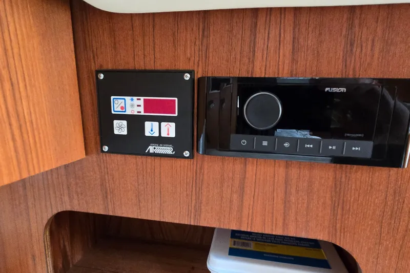Slide: The Image of Control panel and audio system on 2000 Tiara Yachts 3100 Open, featuring wood finish. - 23