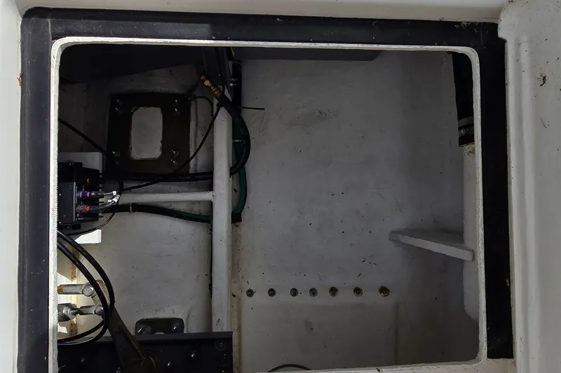 Slide: The Image of Engine compartment of a 2000 Tiara Yachts 3100 Open, showing wiring and structural components. - 31
