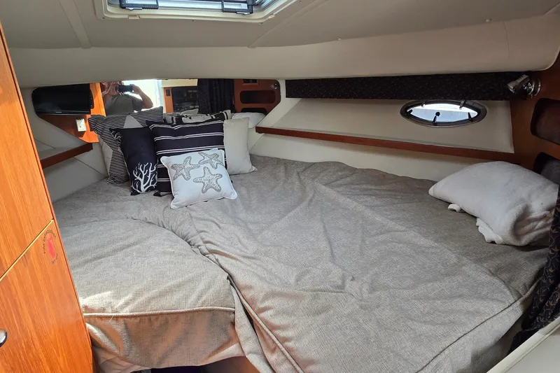 Slide: The Image of Cozy cabin interior of 2000 Tiara Yachts 3100 Open with decorative pillows. - 18