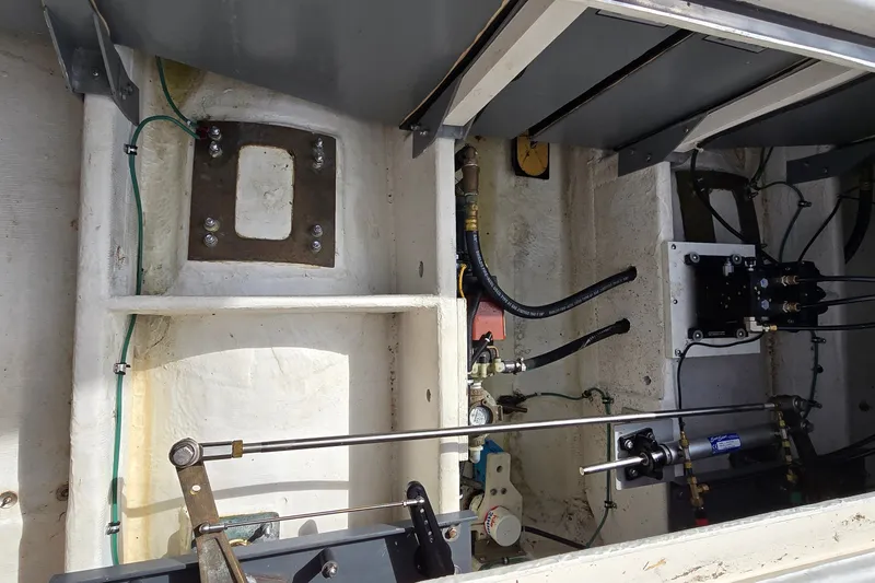 Slide: The Image of Engine compartment of a 2000 Tiara Yachts 3100 Open, showing mechanical components and wiring. - 30