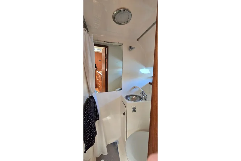 Slide: The Image of Bathroom interior of 2000 Tiara Yachts 3100 Open, featuring sink and shower. - 21