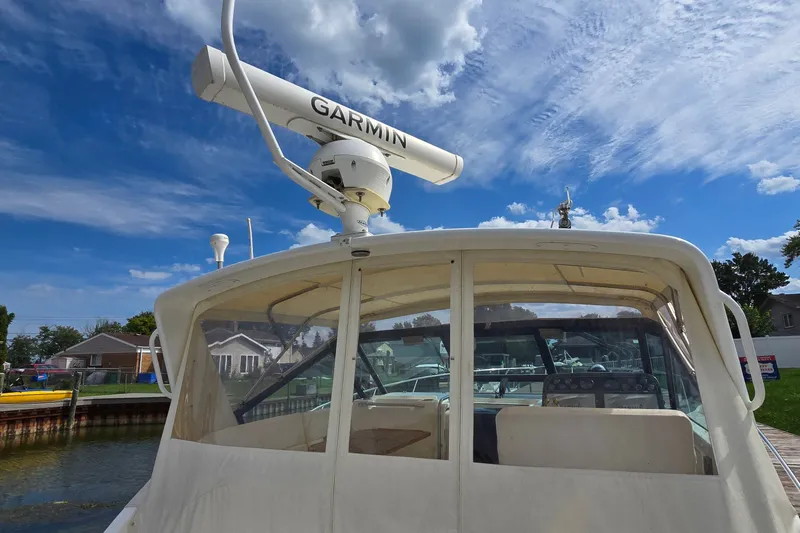 Slide: The Image of 2000 Tiara Yachts 3100 Open with Garmin radar under a clear blue sky. - 5