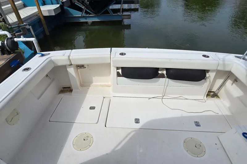 Slide: The Image of 2000 Tiara Yachts 3100 Open boat deck with storage compartments and seating. - 7