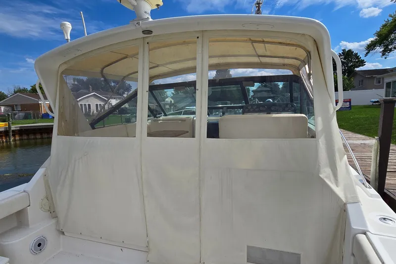 Slide: The Image of 2000 Tiara Yachts 3100 Open with covered cockpit, docked near residential area. - 6