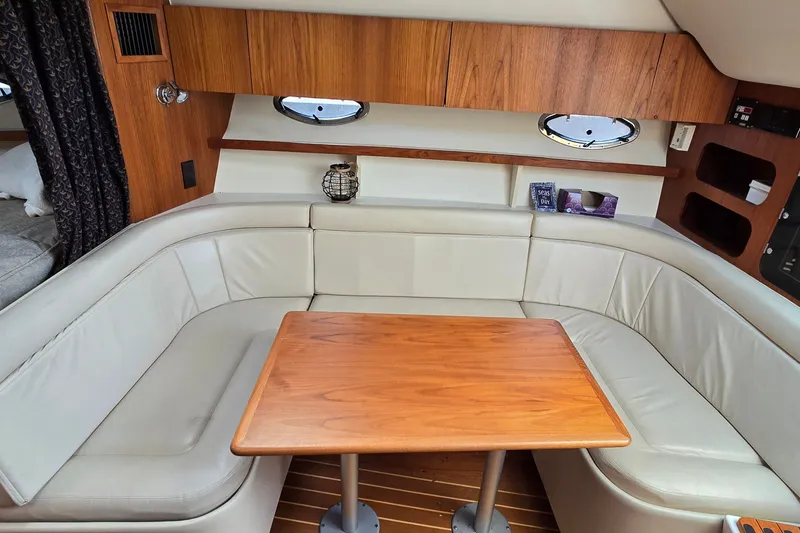 Slide: The Image of Interior of 2000 Tiara Yachts 3100 Open with leather seating and wooden table. - 19