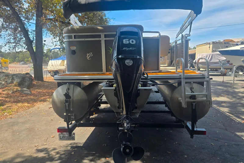 Slide: The Image of 2013 Cypress Cay Seabreeze 210 pontoon boat with 60 HP engine, parked outdoors. - 15
