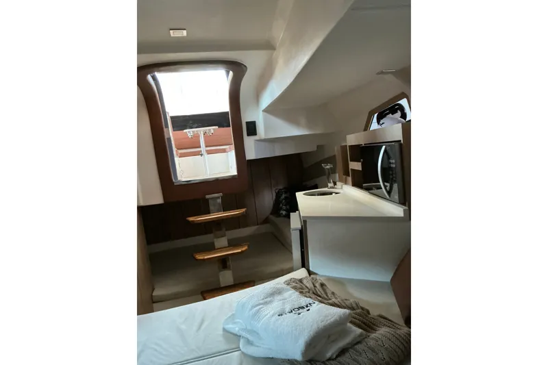 Slide: The Image of Interior of 2027 NX Boats 350 Maximus, featuring modern design and compact amenities. - 19