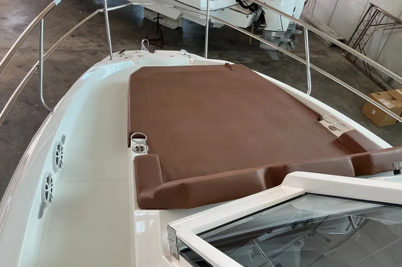 Slide: The Image of 2027 NX Boats 350 Maximus bow with brown sun pad and stainless steel railings. - 16