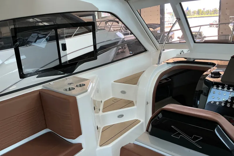 Slide: The Image of Interior of 2027 NX Boats 350 Maximus, featuring modern seating and control panel. - 14