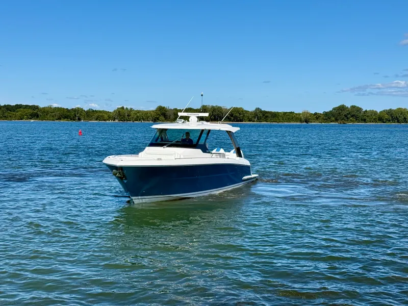 Slide: The Image of 2027 Tiara Yachts 39LS on calm water, featuring a blue hull and white superstructure. - 47