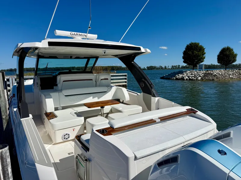 Slide: The Image of 2027 Tiara Yachts 39LS by the water. Sleek design with spacious cockpit and luxurious seating. - 3
