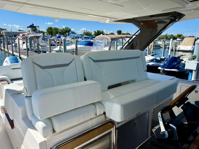 Slide: The Image of The image shows the cockpit of a 2027 Tiara Yachts 39LS with luxurious white seating. - 12