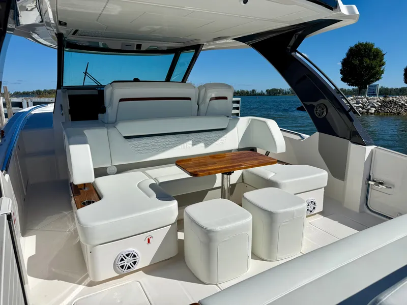 Slide: The Image of The image shows the cockpit of a 2027 Tiara Yachts 39LS with sleek white seating and a wooden table. - 7