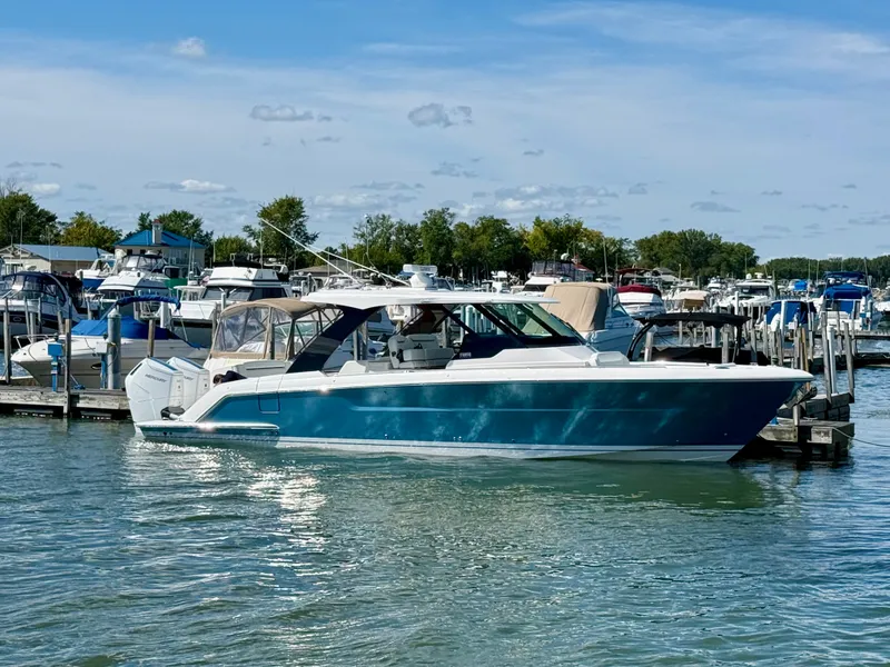 Slide: The Image of A 2027 Tiara Yachts 39LS docked in the water, surrounded by other boats. - 2