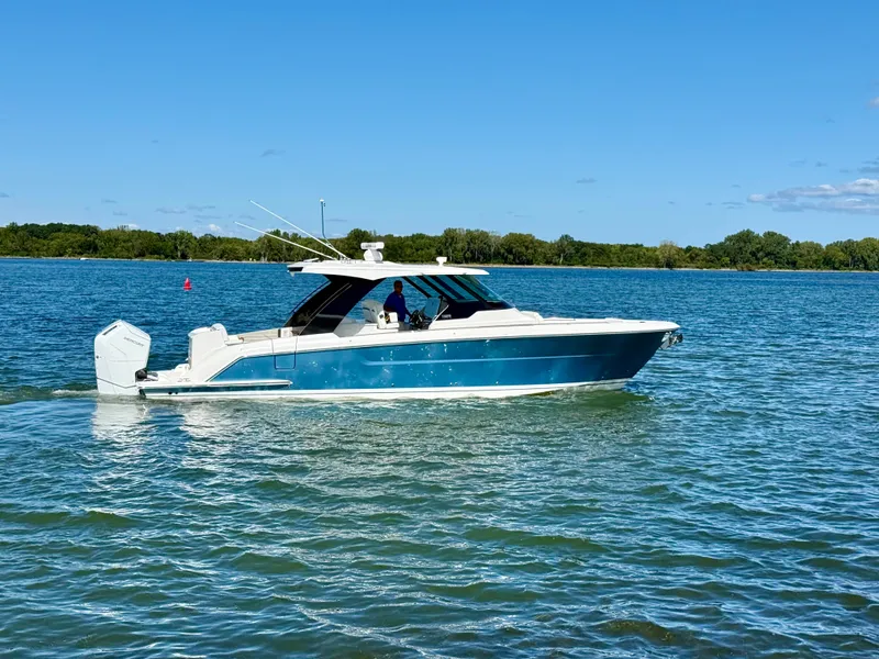 Slide: The Image of A 2027 Tiara Yachts 39LS cruising on calm waters under a clear blue sky. - 45