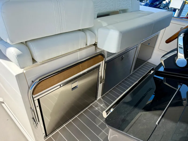 Slide: The Image of The 2027 Tiara Yachts 39LS features an elegant white bench seat and stainless steel galley. - 11