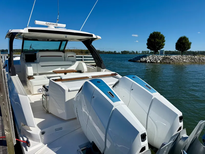 Slide: The Image of The 2027 Tiara Yachts 39LS is docked by the water, featuring two large outboard engines. - 5