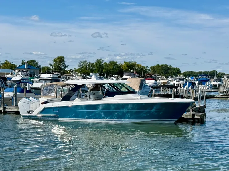 Slide: The Image of A 2027 Tiara Yachts 39LS is docked in the water, surrounded by other boats. - 42