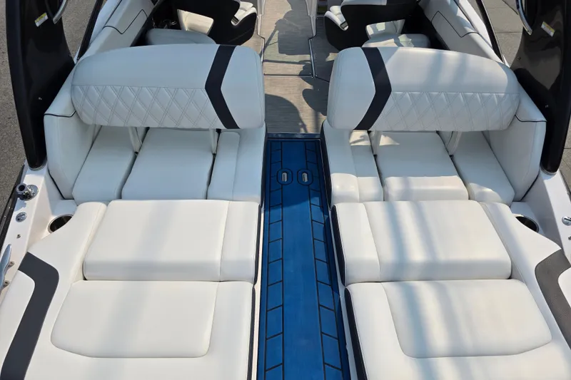 Slide: The Image of 2018 Regal 2300 RX Surf boat interior with white cushioned seating and blue flooring. - 10