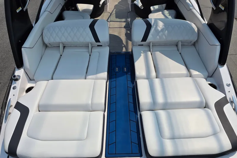 Slide: The Image of Luxurious interior of 2018 Regal 2300 RX Surf boat with white seating and blue accents. - 11