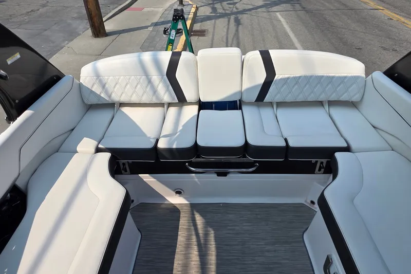 Slide: The Image of 2018 Regal 2300 RX Surf boat interior with white cushioned seating and modern design. - 9