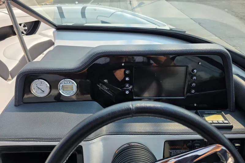 Slide: The Image of 2018 Regal 2300 RX Surf dashboard with gauges and touchscreen display. - 6