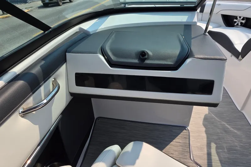 Slide: The Image of Interior view of a 2018 Regal 2300 RX Surf boat, featuring sleek seating and dashboard design. - 7