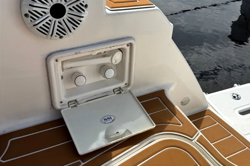 Slide: The Image of 2010 Regal 2860 Window Express boat shower controls and speaker on deck. - 14