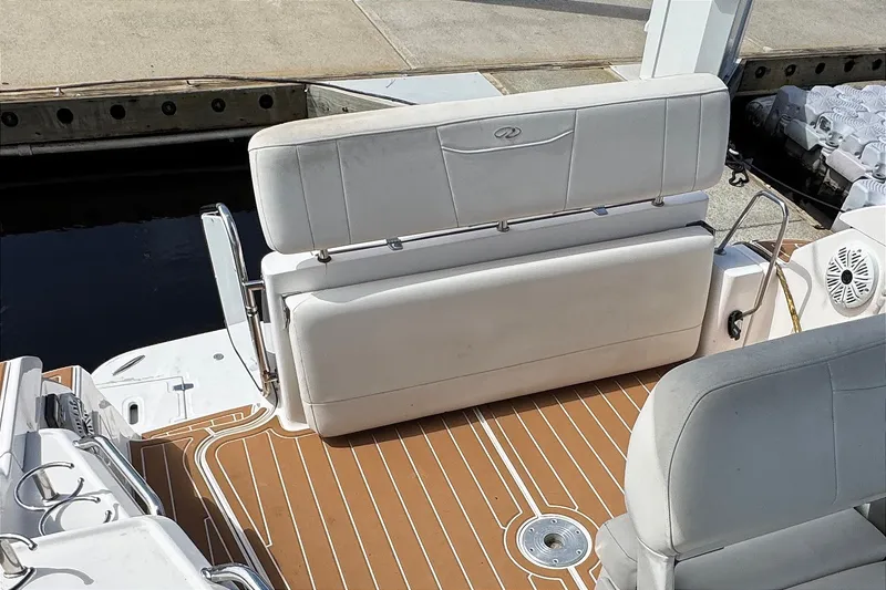 Slide: The Image of 2010 Regal 2860 Window Express boat interior with white seating and teak-style flooring. - 17