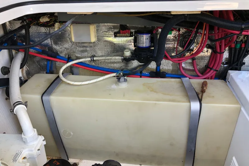 Slide: The Image of Engine compartment of a 2010 Regal 2860 Window Express boat, showing wiring and fuel tank. - 19