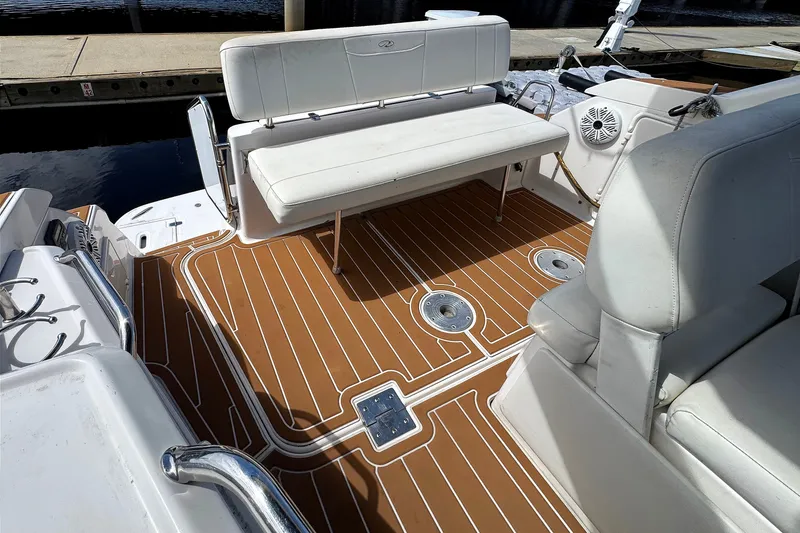 Slide: The Image of 2010 Regal 2860 Window Express boat interior with white seating and teak-style flooring. - 16