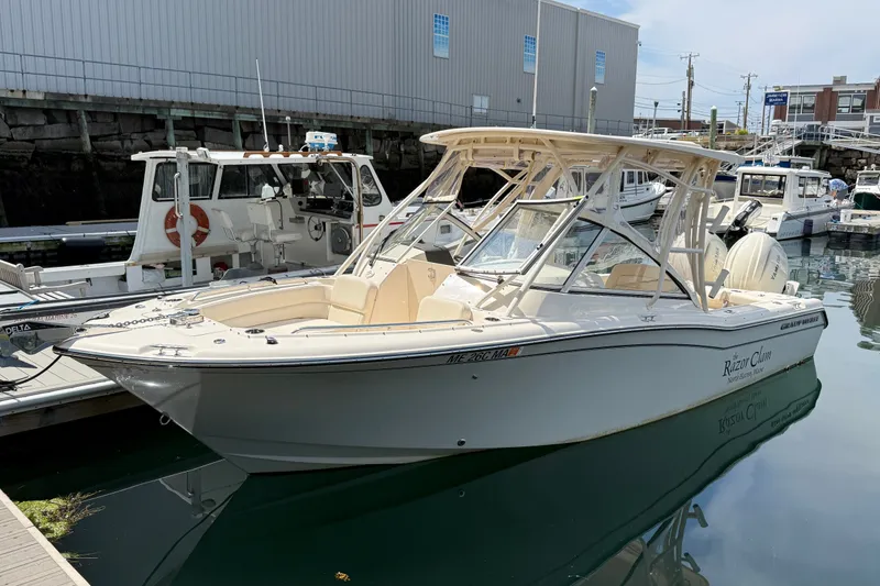 Slide: The Image of 2024 Grady-White Freedom 255 boat docked in marina, side view. - 1