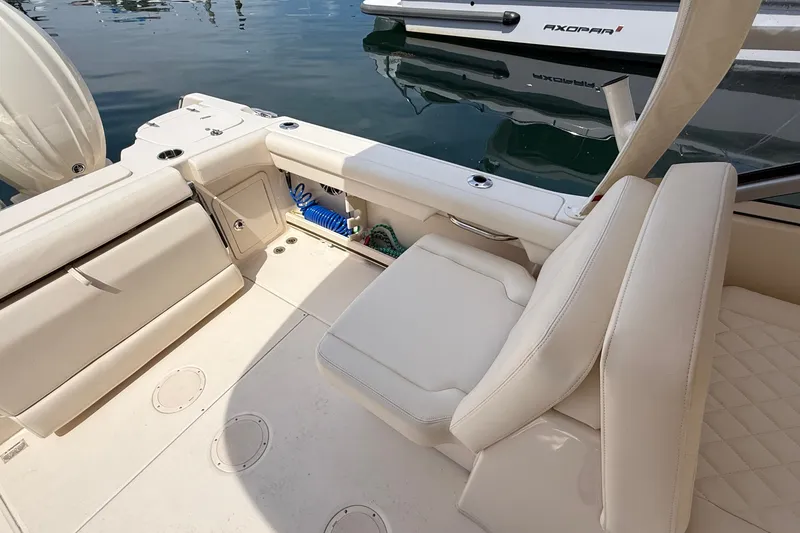 Slide: The Image of 2024 Grady-White Freedom 255 boat interior with cushioned seating and storage compartments. - 6