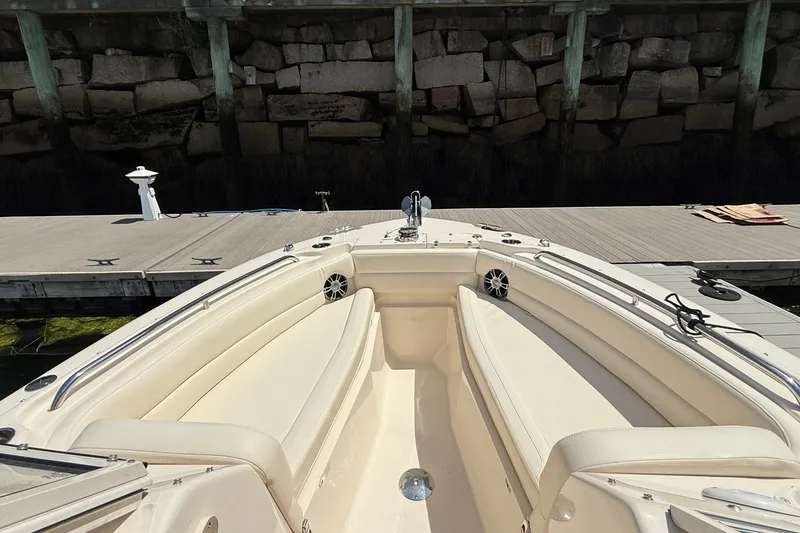 Slide: The Image of 2024 Grady-White Freedom 255 boat docked, showcasing spacious seating and sleek design. - 2