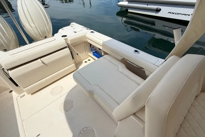 Slide: The Image of 2024 Grady-White Freedom 255 boat interior with beige seating and storage compartments. - 7