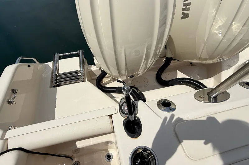 Slide: The Image of 2024 Grady-White Freedom 255 boat stern with Yamaha engines and swim ladder. - 12