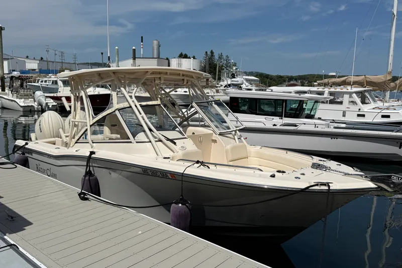 The Image of 2024 Grady-White Freedom 255 boat docked at marina under clear sky. - 0