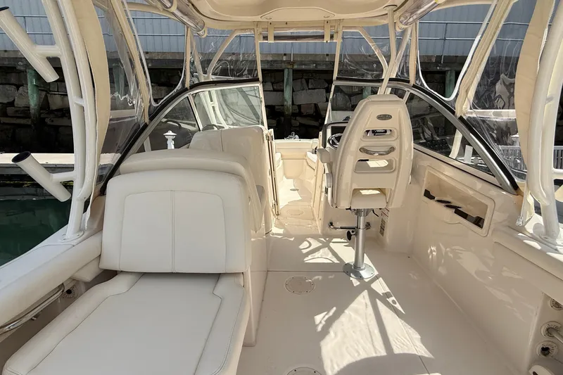 Slide: The Image of 2024 Grady-White Freedom 255 boat interior with white seating and helm station. - 9