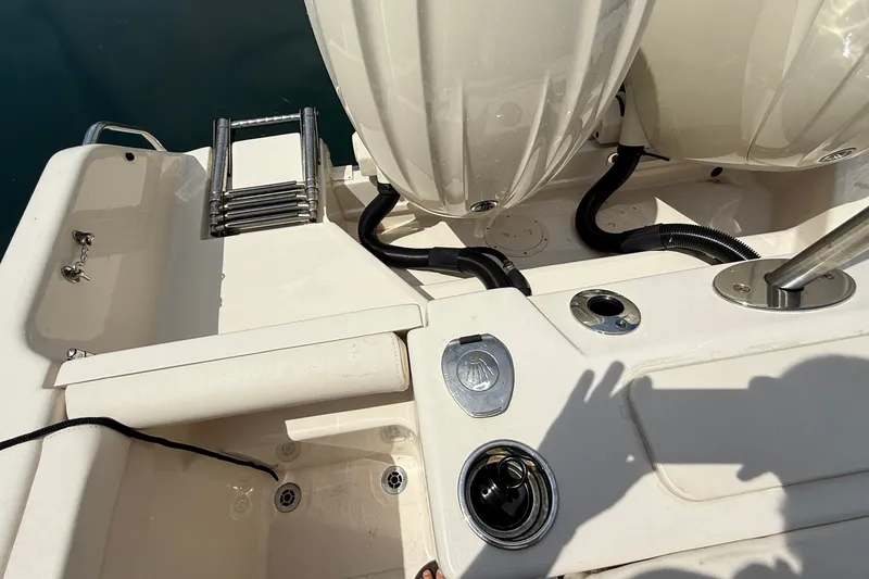 Slide: The Image of 2024 Grady-White Freedom 255 boat deck with ladder and engine components. - 13